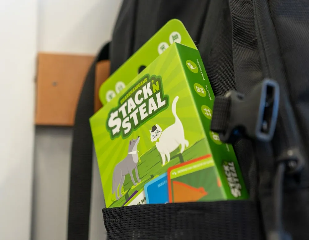 A box of Stack 'n Steal tucked into the pocket of a backpack