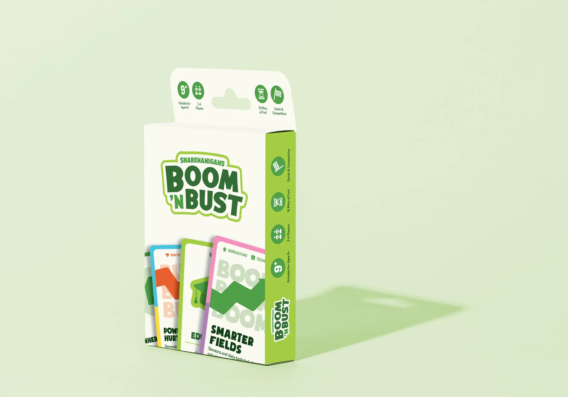 The Boom 'n Bust box standing on a pale green surface, its cards showing at the front